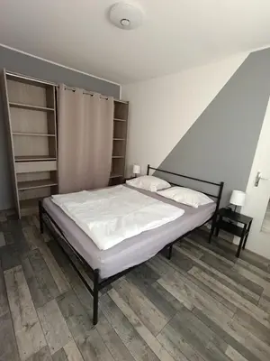 a bedroom with a bed with white sheets at Maison de campagne in Lançon-Provence