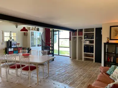 a living room with a table and chairs at Gite des amis Domaine de Mas Caron in Caromb