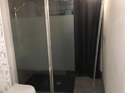 a shower with a glass door in a bathroom at Maison de village - Monteux centre - Provence in Monteux
