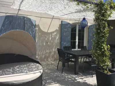 a large black table with chairs and a blue light at Villa vue imprenable sur château in Ansouis