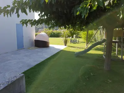 a large swimming pool in a yard with grass at Villa vue imprenable sur château in Ansouis