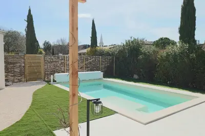 a swimming pool in the yard of a house at Le mas Sainte Marie in Venasque