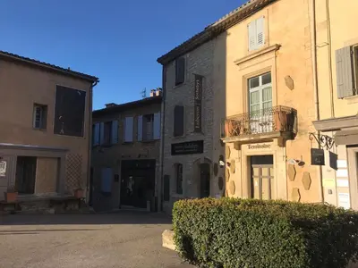 a group of buildings in a street at Le Bastidon de L Olivier in Gordes