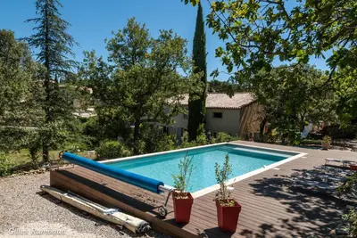 a swimming pool with a baseball bat on a deck at Mas du Kairos - Gite Romarin in Venasque