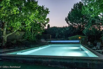 a swimming pool in a yard with trees at Mas du Kairos - Gite Romarin in Venasque