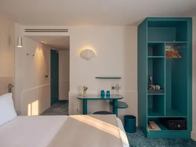 a bedroom with a bed and a table at Hôtel Saint Christophe Aix en Provence Centre Ville in Aix-en-Provence