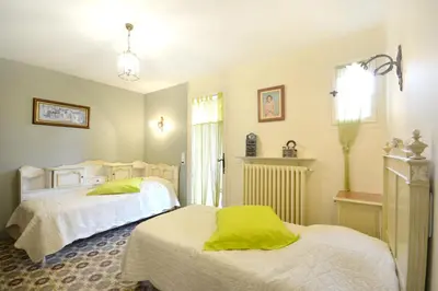 a bedroom with two beds and a window at Maison charmante au Thor + Piscine in Le Thor