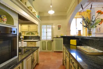 a large kitchen with a sink and a counter at Maison charmante au Thor + Piscine in Le Thor