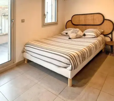 a bed sitting in a room with at Studio moderne à Aix-en-Provence - 20 m² avec terrasse ! in Aix-en-Provence