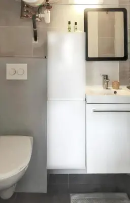 a bathroom with a sink and a toilet and a mirror at Studio moderne à Aix-en-Provence - 20 m² avec terrasse ! in Aix-en-Provence