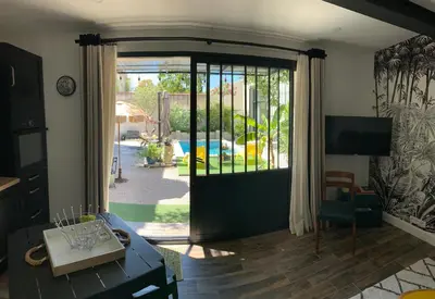 a living room with a sliding glass door to a yard at Cosy Studio en Provence in Carpentras