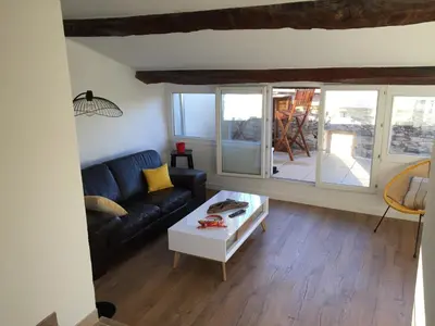 a living room with a couch and a table at Chez Marius Gordes Vue panoramique sur luberon in Gordes