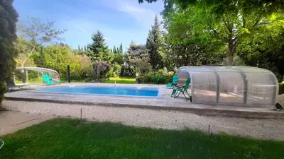 a tent next to a swimming pool in a yard at Maison Le Thor avec piscine part. in Le Thor