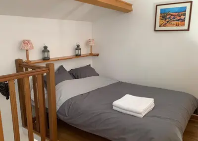 a bedroom with a bed with two towels on it at La Forge - Gordes in Gordes