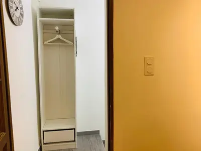 a closet with a door and a clock on a wall at MAZZARIN STUDIO in Aix-en-Provence