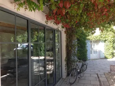 a bike parked next to a building with glass doors at The Willow Tree in Le Thor