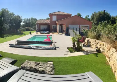 a swimming pool with a pink flamingo in a yard at Chambre privée indépendante au cœur du Luberon in Saint-Saturnin-les-Apt