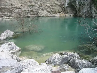 a pool of water with rocks in a river at La Pastorale in Lagnes