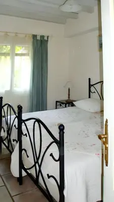 a bedroom with a large bed with white sheets at Villa charmante à Dauphin avec piscine privée in Dauphin