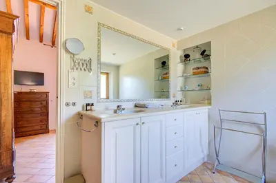a bathroom with a sink and a mirror at Les Chambres du Perussier in Cucuron