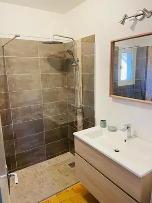 a bathroom with a shower and a sink at Maison La Plaine in Lourmarin