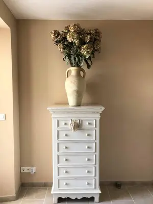 a vase on top of a white dresser with a bouquet of flowers at Provence Luberon Bonnieux location gite chez Marcelle in Bonnieux