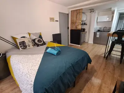 a bedroom with a bed with a blue towel on it at Studio Bon pasteur hyper centre Aix in Aix-en-Provence
