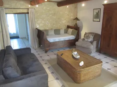 a living room with a couch and a table at Maison provençal avec PISCINE in Cavaillon