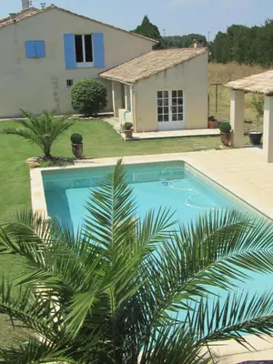 a swimming pool in front of a house at Maison provençal avec PISCINE in Cavaillon