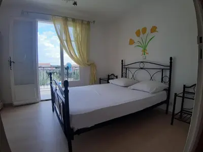 a bedroom with a bed and a large window at Relaxing Provence Hideaway in Carpentras