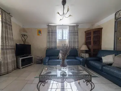 a living room with a blue couch and a table at Relaxing Provence Hideaway in Carpentras