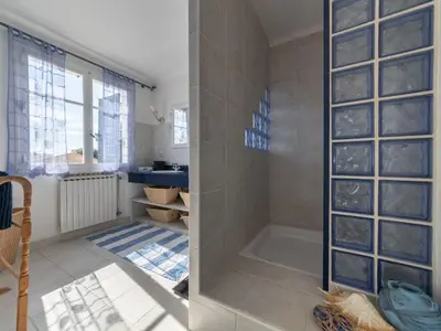 a bathroom with a shower with a glass wall at Relaxing Provence Hideaway in Carpentras