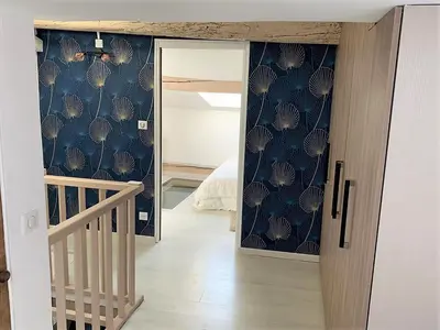 a room with a hallway with a staircase and a blue wall at LE FOCH in Aix-en-Provence
