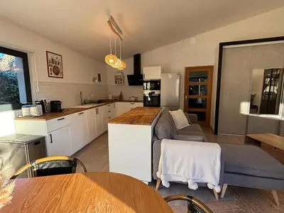 a kitchen with a couch and a table in a room at Domaine Hestia in Robion en Luberon