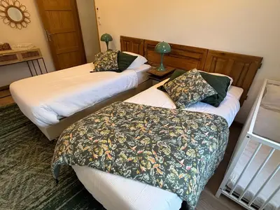 two beds in a hotel room with sidx sidx sidx sidx at Domaine Hestia in Robion en Luberon