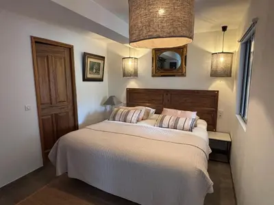 a bedroom with a bed and a mirror on the wall at Domaine Hestia in Robion en Luberon