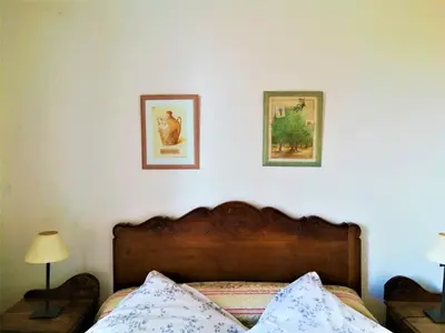 a bedroom with a bed and two pictures on the wall at Embarben Maison d'hôtes in Saint-Chamas