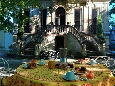 a table with food on it in front of a building at Embarben Maison d'hôtes in Saint-Chamas