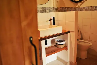 a bathroom with a sink and a toilet at Embarben Maison d'hôtes in Saint-Chamas