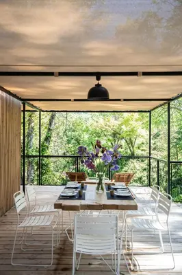 a dining room with a table and chairs at Les Cabanes de la Fontaine in Lacoste
