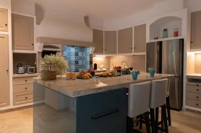 a dining room with a table and chairs and a mirror at Mas 9 Romanin - Mas Provençal Familial in Saint-Rémy-de-Provence