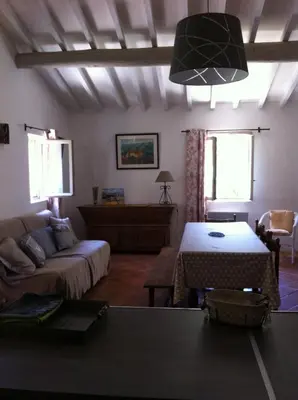 a living room with a couch and a table at Gardiole in Bonnieux
