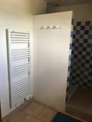a bathroom with a white door and a shower at La Bastide de l'Olivier in Flassan
