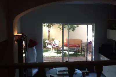 a view of a living room with a door to a patio at La maison de Tao in Aix-en-Provence
