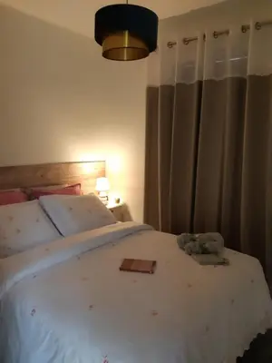 a bedroom with a bed with a teddy bear on it at Vue panoramique sur le château,montagne et grottes in Fontaine-de-Vaucluse