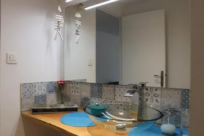 a bathroom counter with a sink and a mirror at Studio charmant au calme in Aix-en-Provence