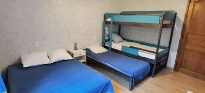 a room with two bunk beds and a ladder at Loue haut de villa au calme piscine jardin arboré in Cornillon-Confoux