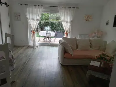 a living room with a couch and a large window at La perle des Alpilles Résidence les MYRTILLES in Eyguières
