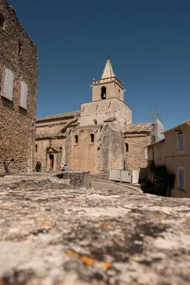 an old building with a tower on top of it at Les Maisons Mado in Venasque