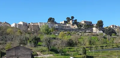 a town on top of a hill with houses at L'Ensoleillée in Ménerbes